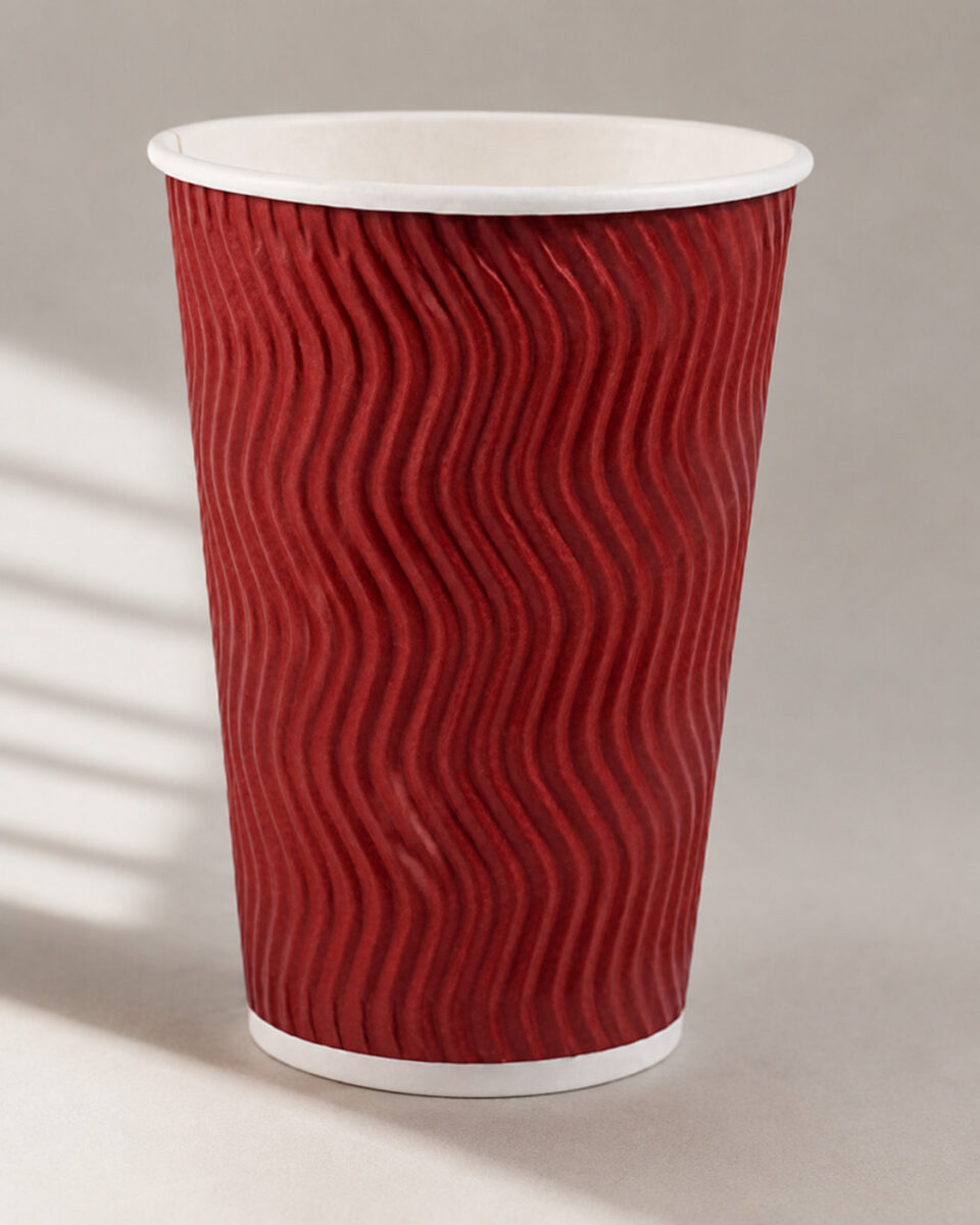 Red coffee cup with vertical wavy ripple walls, a white rolled rim and white base band