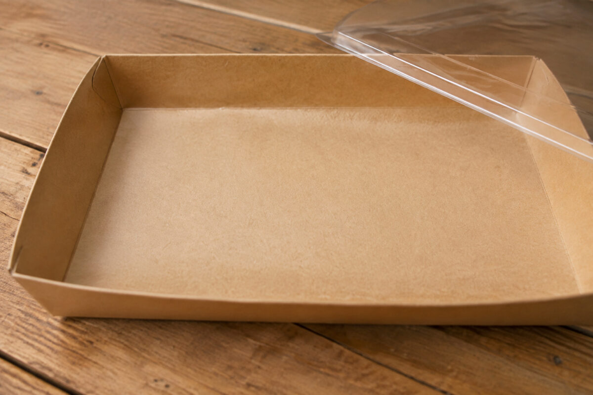 Inside view of a shallow kraft paper dessert tray with a clear lid beside it