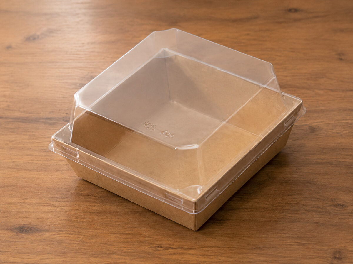 Empty square kraft dessert tray with a clear molded angular lid