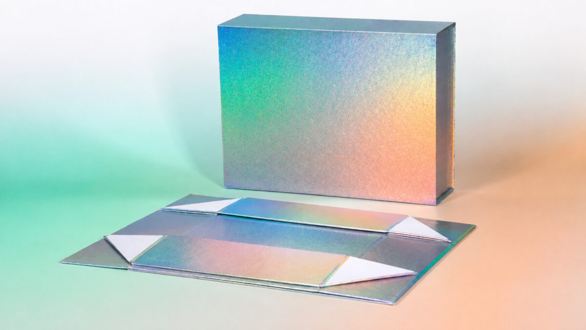 Assembled iridescent gift box beside its flat folding blank