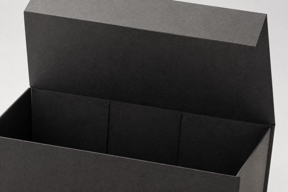 Interior detail of an empty charcoal folding gift box with its lid raised