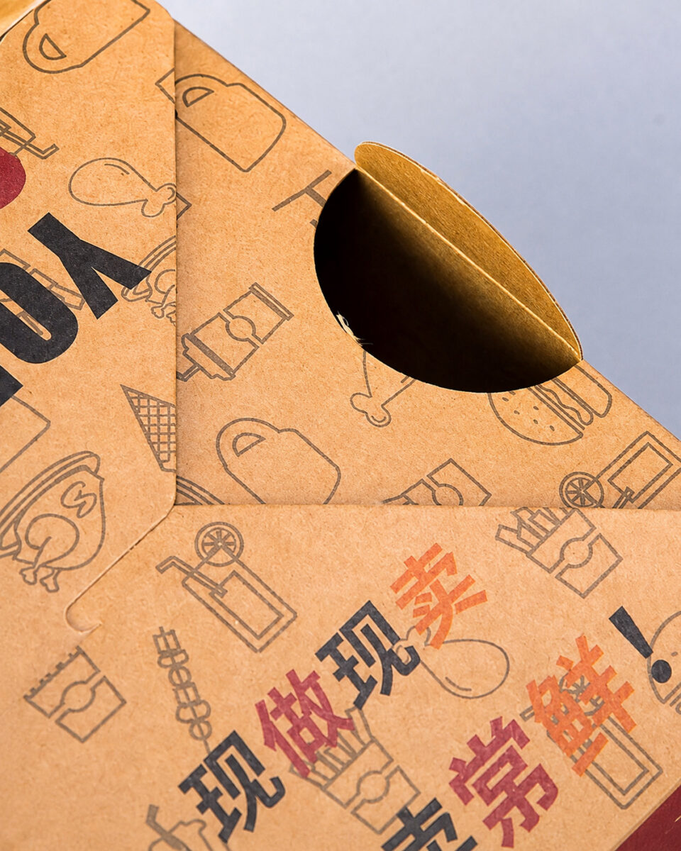 Close-up of an opened circular vent in a printed kraft takeaway carton