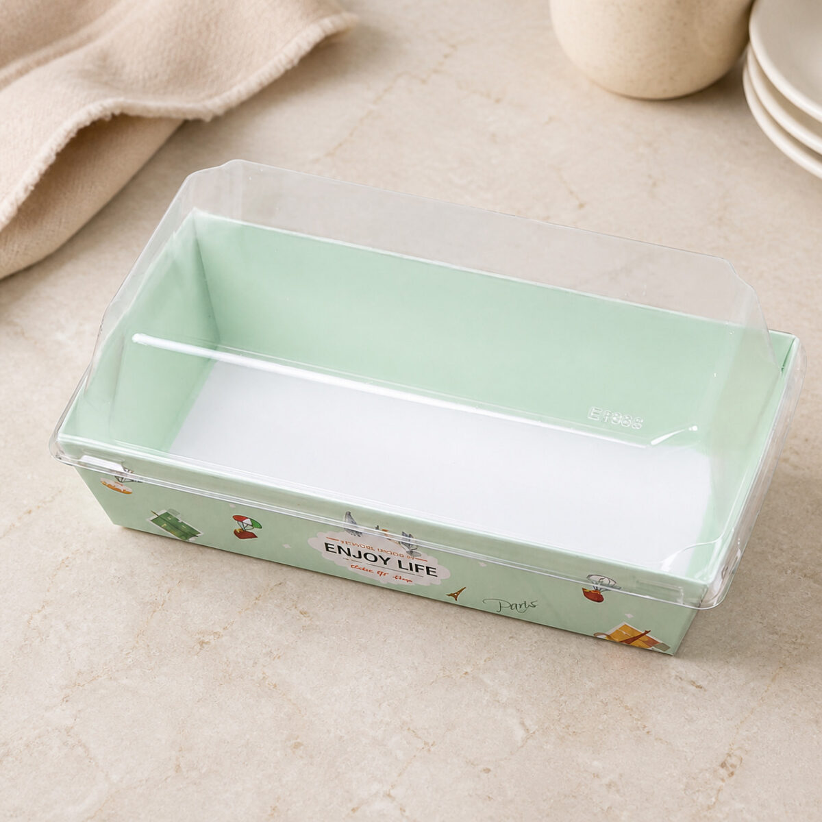 Empty mint printed dessert tray with a white interior floor and raised transparent rectangular cover