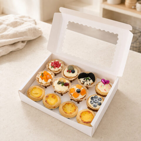 Window Dessert Boxes with Portion Dividers Open white window bakery box with an insert holding four egg tarts and eight decorated cupcakes